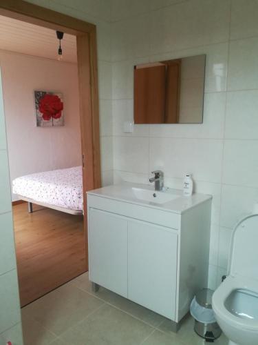 a bathroom with a sink and a toilet and a bed at Villa Luz - Family House Vacations- Large Private Outdoor Area in Santa Cruz