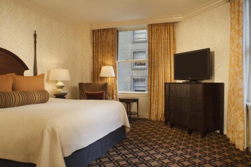 a hotel room with two beds and a television at Omni San Francisco in San Francisco