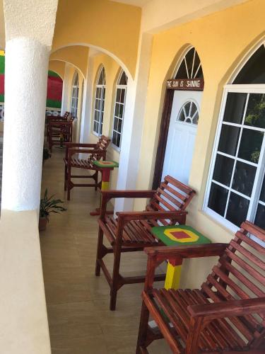 a group of chairs sitting outside of a building at Solet's Paradise Negril in Negril