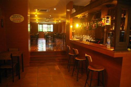 a bar in a restaurant with bar stools at Aonang Inn in Krabi town