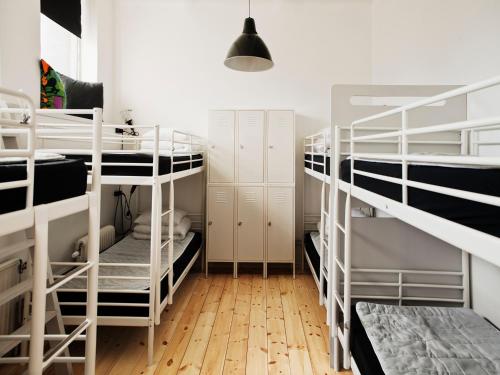 a room with three bunk beds and a hallway at City Backpackers Hostel in Stockholm
