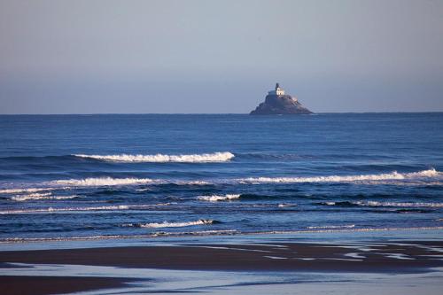 an island in the ocean with a lighthouse on it at Lighthouse Inn in Cannon Beach
