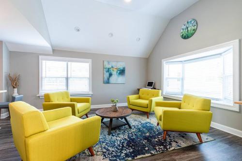 a living room with yellow chairs and a table at *Pet Friendly* stay in Historic Carytown in Richmond