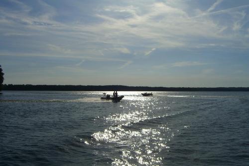 a group of people in a boat in the water at Dom Wczasowy Pięciu Pomostów in Czaplinek