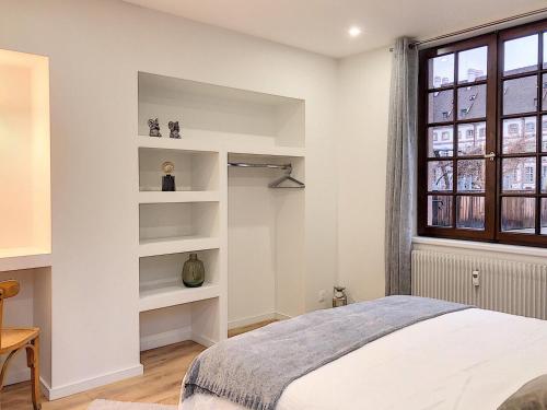 1 dormitorio con paredes blancas, 1 cama y ventana en LOVELY COLMAR en Colmar