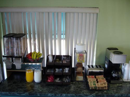 a kitchen with a counter with food and a window at Antilley Inn in Abilene