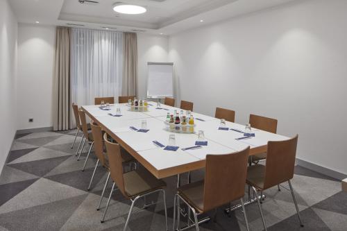a conference room with a large table and chairs at Holiday Inn Express - Merzig by IHG in Merzig