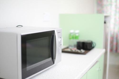 a microwave oven sitting on a counter in a kitchen at Akar Hotel Kampung Baru in Kuala Lumpur