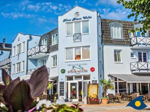 a white building with a store in front of it at Blaue Welle Whg 11 "Marius" in Bansin
