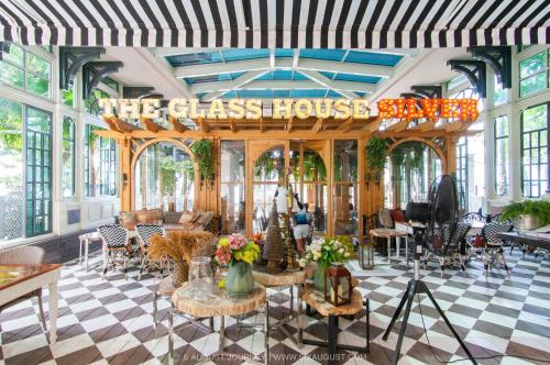 a room with a sign that reads the glass house at Hotel Romeo Palace Pattaya in North Pattaya