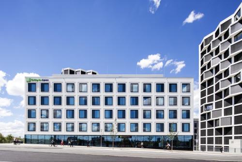 a white building with many windows on a street at Holiday Inn Express Munich City West by IHG in Munich