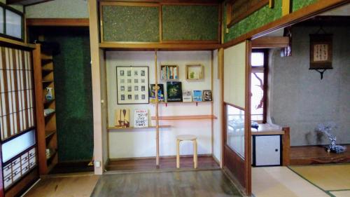 a room with a table and a chair in a room at HACHI in Odate