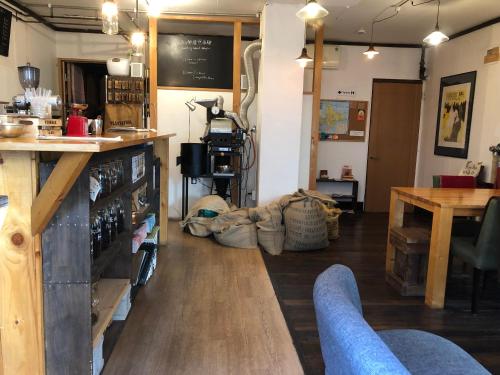 a room with a bar and a table and a counter at Guest House Yasube in Sapporo