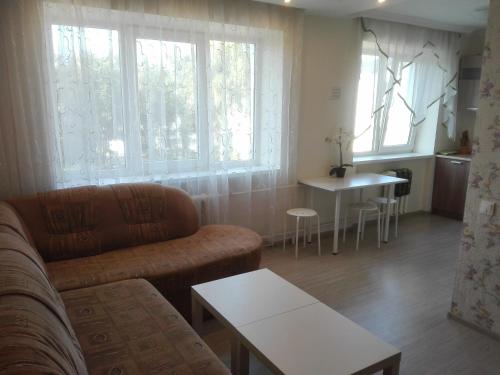 a living room with a couch and a table at Двухкомнатная квартира Smart-Home in Daugavpils