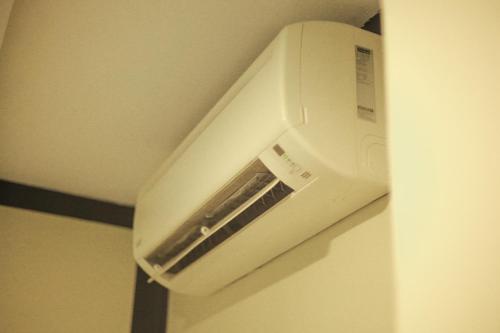 a white toaster oven hanging on a wall at HOTEL PREMIUM in Ipoh