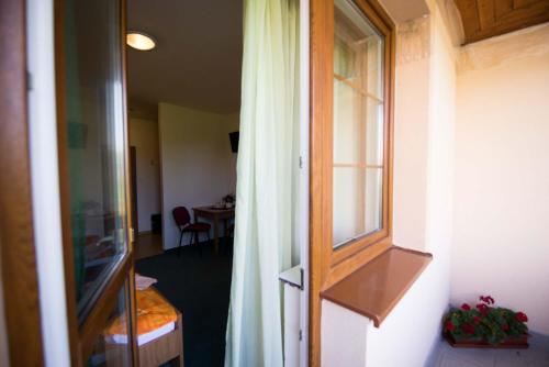 an open door to a room with a window at Penzión Krahule in Kremnica