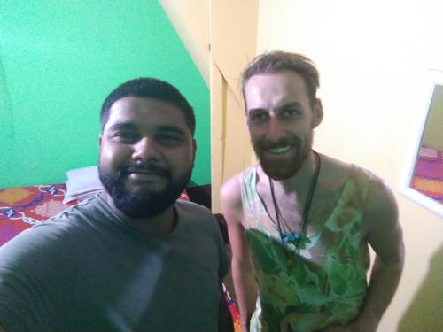deux hommes debout côte à côte dans une pièce dans l'établissement Atathi Niwas Guest House for Backpackers and Travellers, à Siliguri