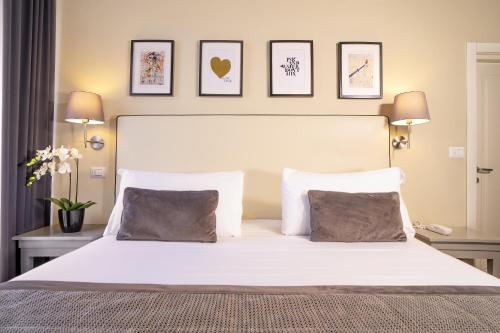 A bed or beds in a room at Dedo Boutique Hotel