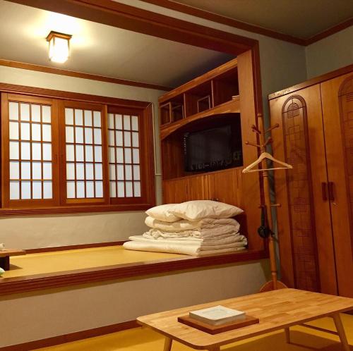 a room with a pile of towels on a shelf at BluePlanet in Gyeongju