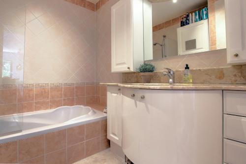 La salle de bains est pourvue d'une baignoire, d'un lavabo et d'une baignoire. dans l'établissement Modern Family Home 5 min to Beach +Pool +Garage, à Antibes