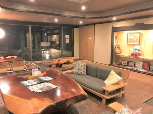 a living room with a couch and a table at K's House Hostels - Hakone Yumoto Onsen in Hakone