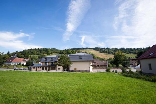 a house on a hill with a green field at Penzión Krahule in Kremnica