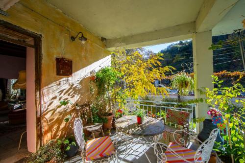 a patio with a table and chairs on a balcony at Tina's Country Home in Askas