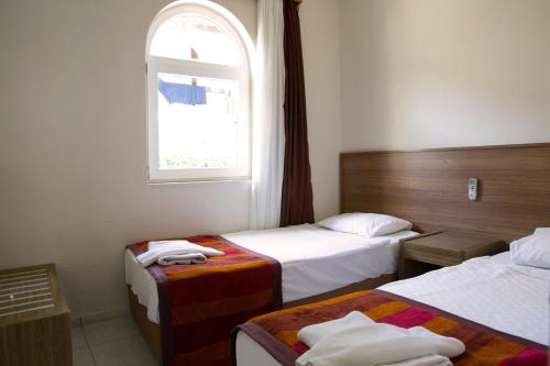 Ein Bett oder Betten in einem Zimmer der Unterkunft Greenport Bodrum Hotel
