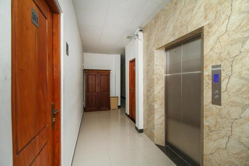 an empty hallway with a door and a hallway with a hallway at Grand Rovinka Hotel in Dehiwala