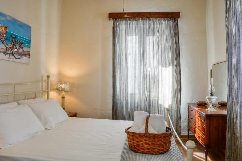 a bedroom with a white bed and a window at The Veranda of Gavrion-Exclusive, Centrally located with Seaview in Gavrion