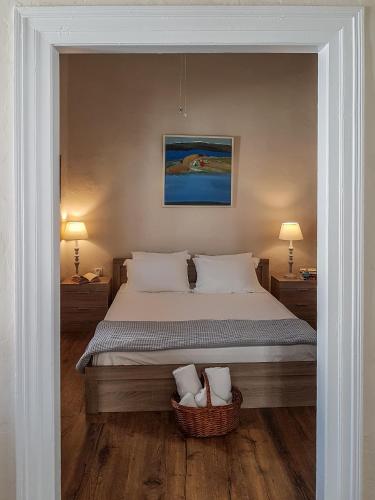 a bedroom with a large bed with a basket at The Veranda of Gavrion-Exclusive, Centrally located with Seaview in Gavrion