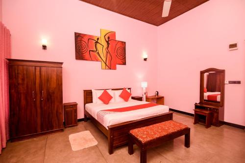 a bedroom with a bed and a mirror in it at Man Mountain Villa in Matale