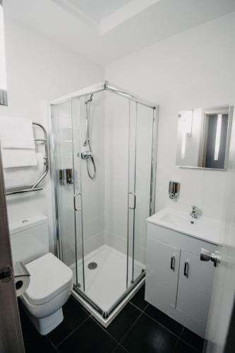a bathroom with a shower and a toilet and a sink at Banff Springs Hotel in Banff