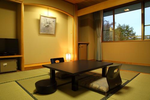 a living room with a table and chairs at Hotel Oak Forest in Hakuba