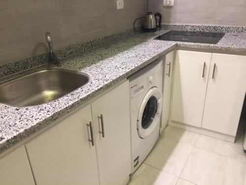 a kitchen with a sink and a washing machine at Marilyn Studio with Sea View Wi Fi in Hurghada