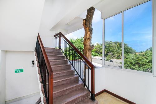 a staircase in a house with large windows at Arken Lanka in Galle