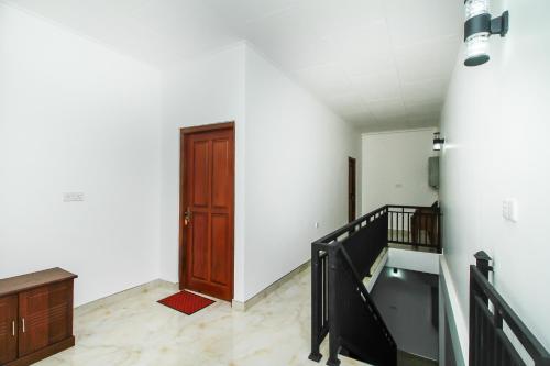 an empty room with a staircase and a door at Ryan Residence & Restaurant in Negombo