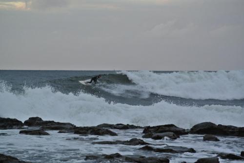 a man riding a wave on a surfboard in the ocean at Huskisson Beach Motel in Huskisson