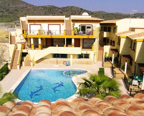 a house with a swimming pool with dolphins in it at Bahia El Calon in San Juan de los Terreros