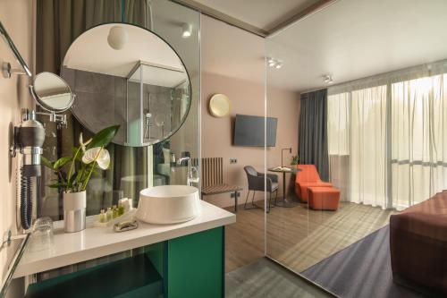 a bathroom with a sink and a mirror at Cortile Hotel - Adults Only in Budapest