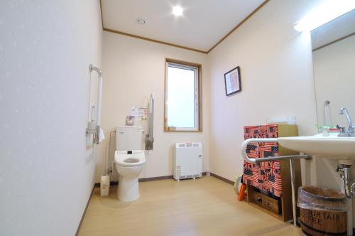 a bathroom with a toilet and a sink at Polaris in Teshikaga