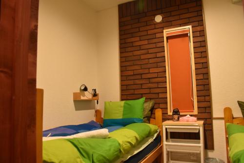 Кровать или кровати в номере Niseko Hirafu Tsukushi