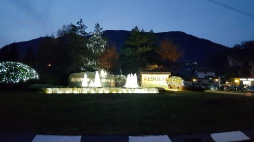 a monument in a park at night at Casa Ramus Valle Camonica a 30 km dal Passo Tonale in Edolo