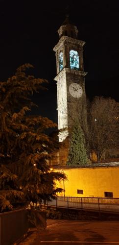 a large clock tower with a clock on it at Casa Ramus Valle Camonica a 30 km dal Passo Tonale in Edolo