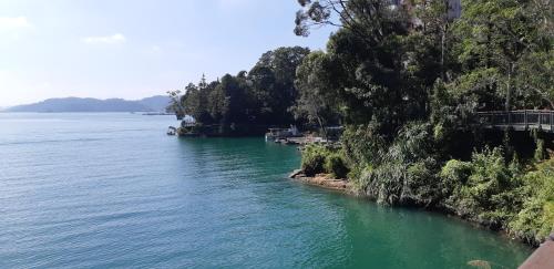 a river with green water and trees on the shore at Ze Hu B&B in Yuchi