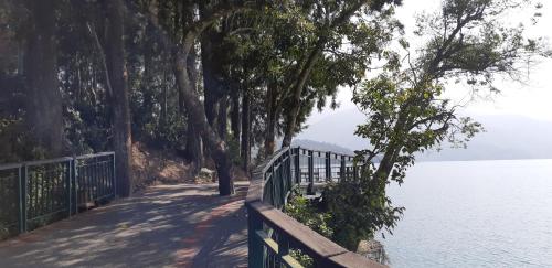 a wooden walkway next to a body of water at Ze Hu B&B in Yuchi