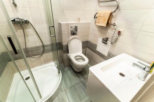 a bathroom with a shower and a toilet and a sink at Wonderful flat on city center (Mukachivska 4/21) in Uzhhorod