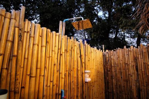 a wooden fence with a broom on top of it at Tropical Hostel in Ko Phayam