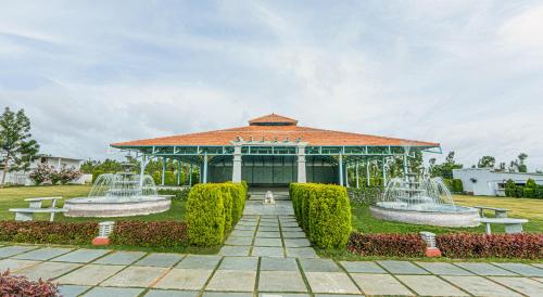 a pavilion with two water fountains in a park at Fiestaa Resort n Events Venue in Devanahalli-Bangalore