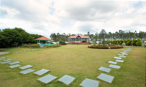 a park with white squares on the grass at Fiestaa Resort n Events Venue in Devanahalli-Bangalore